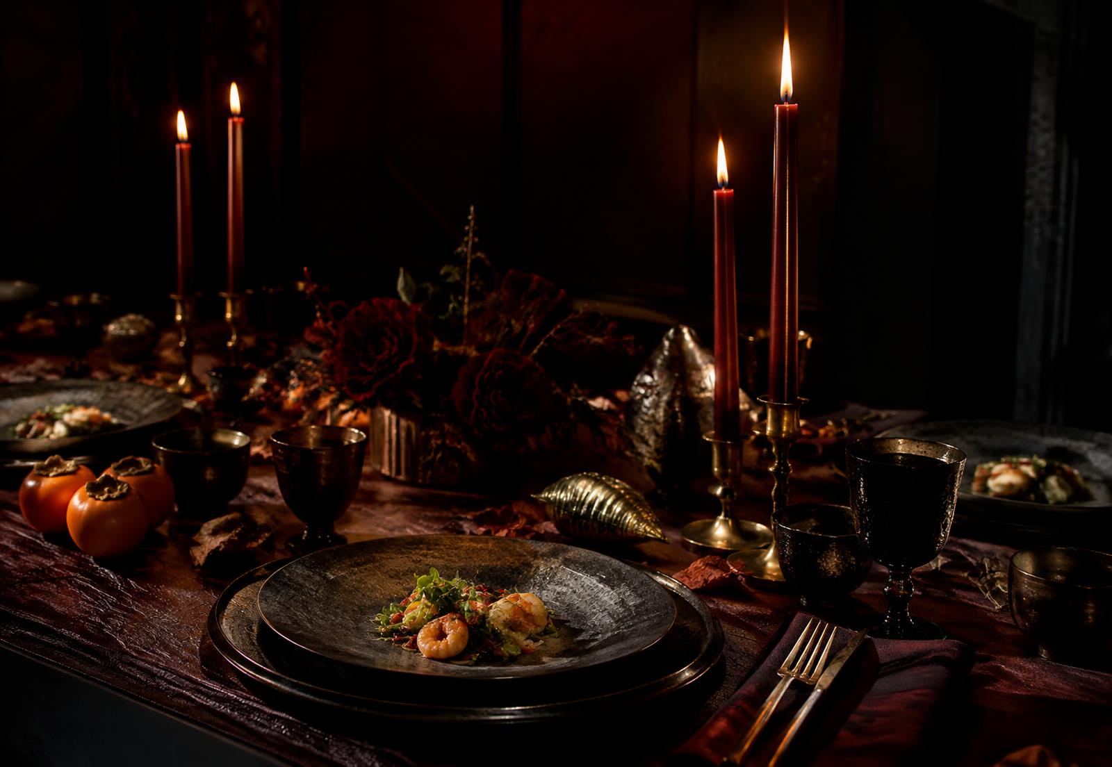 Candlelit autumn supper table in oxblood and brass