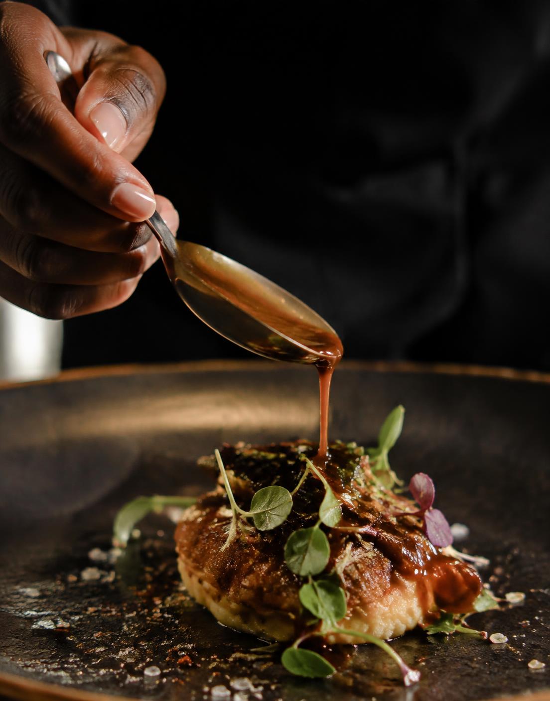 Sauce spooned over a finely plated dish